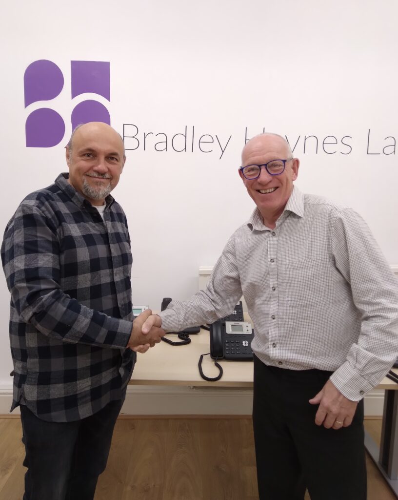 Robert Bradley and Gary Roskell shaking hands